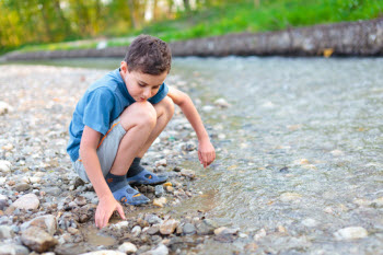 Child Playing in Creek